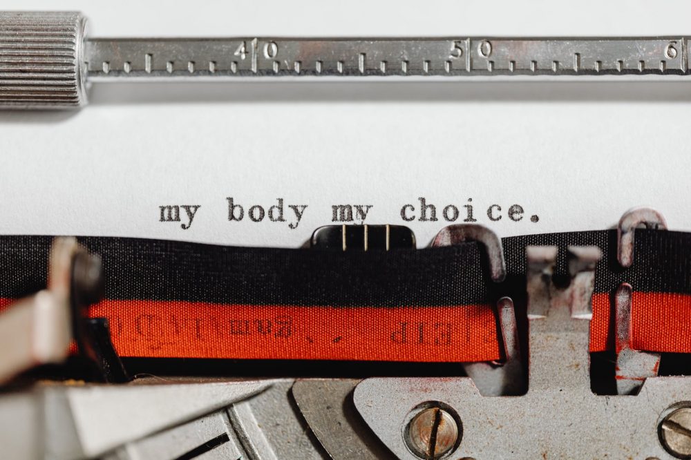 feminist slogan coming out of a typewriter