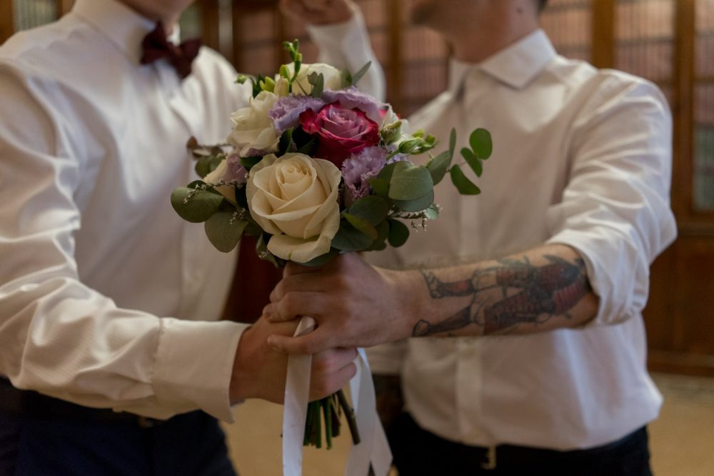 couple holding a bouquet of flowers
