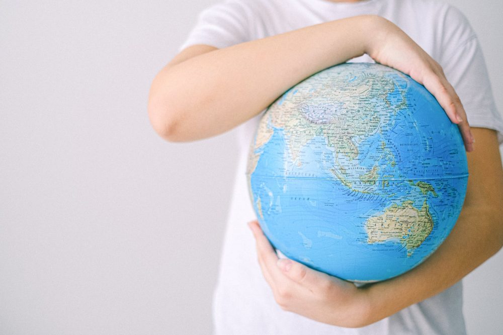a person holding a globe
